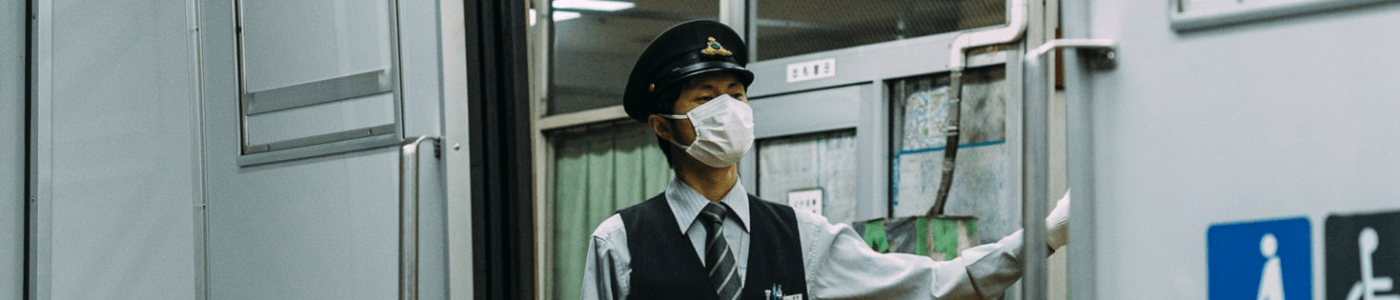 subway conductor wearing a mask