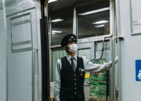 subway conductor wearing a mask